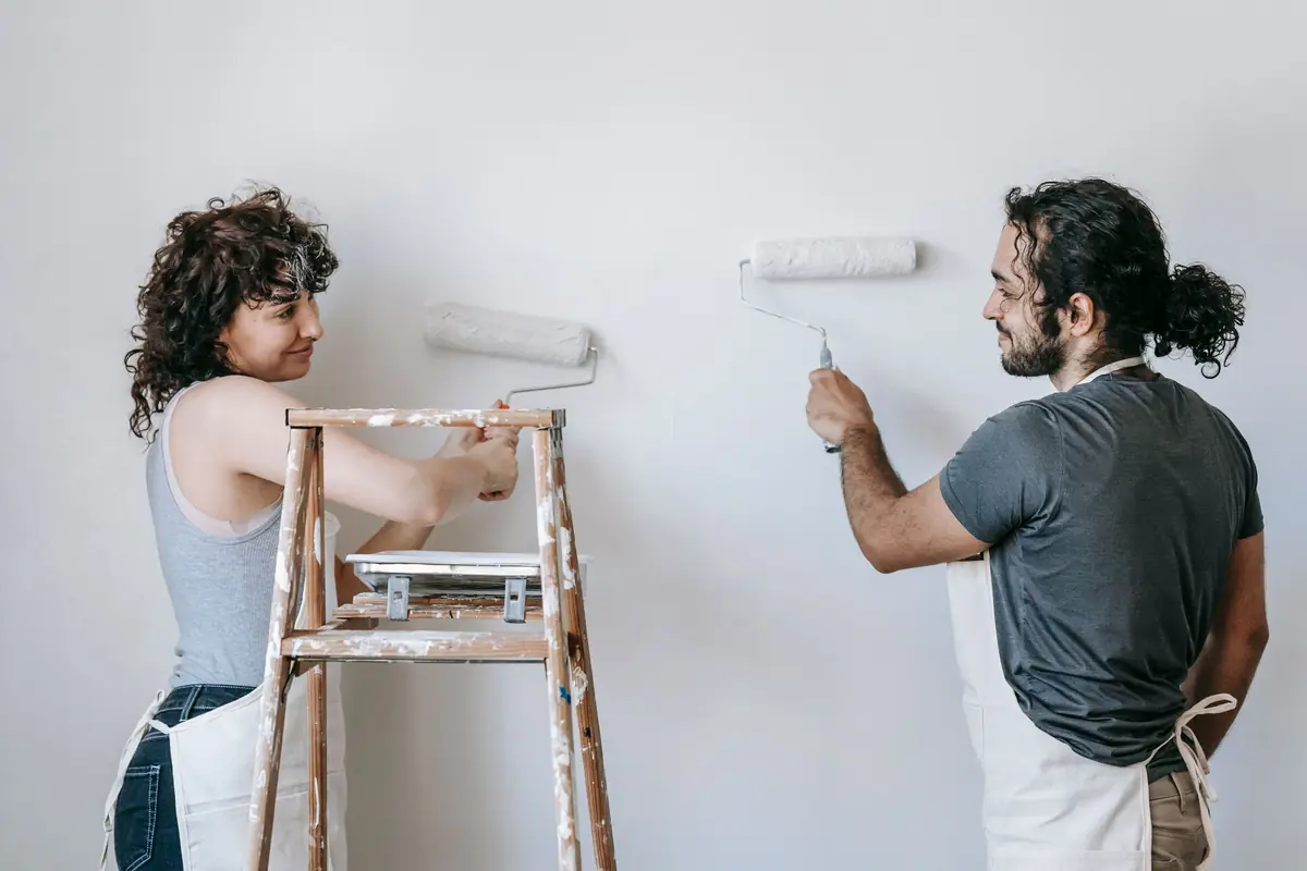 People painting a wall together — painting help in Tampa