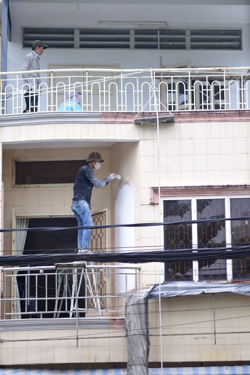Painters on scaffolding at a building facade